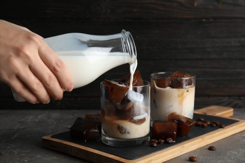 Pouring milk over coffee ice-cubes